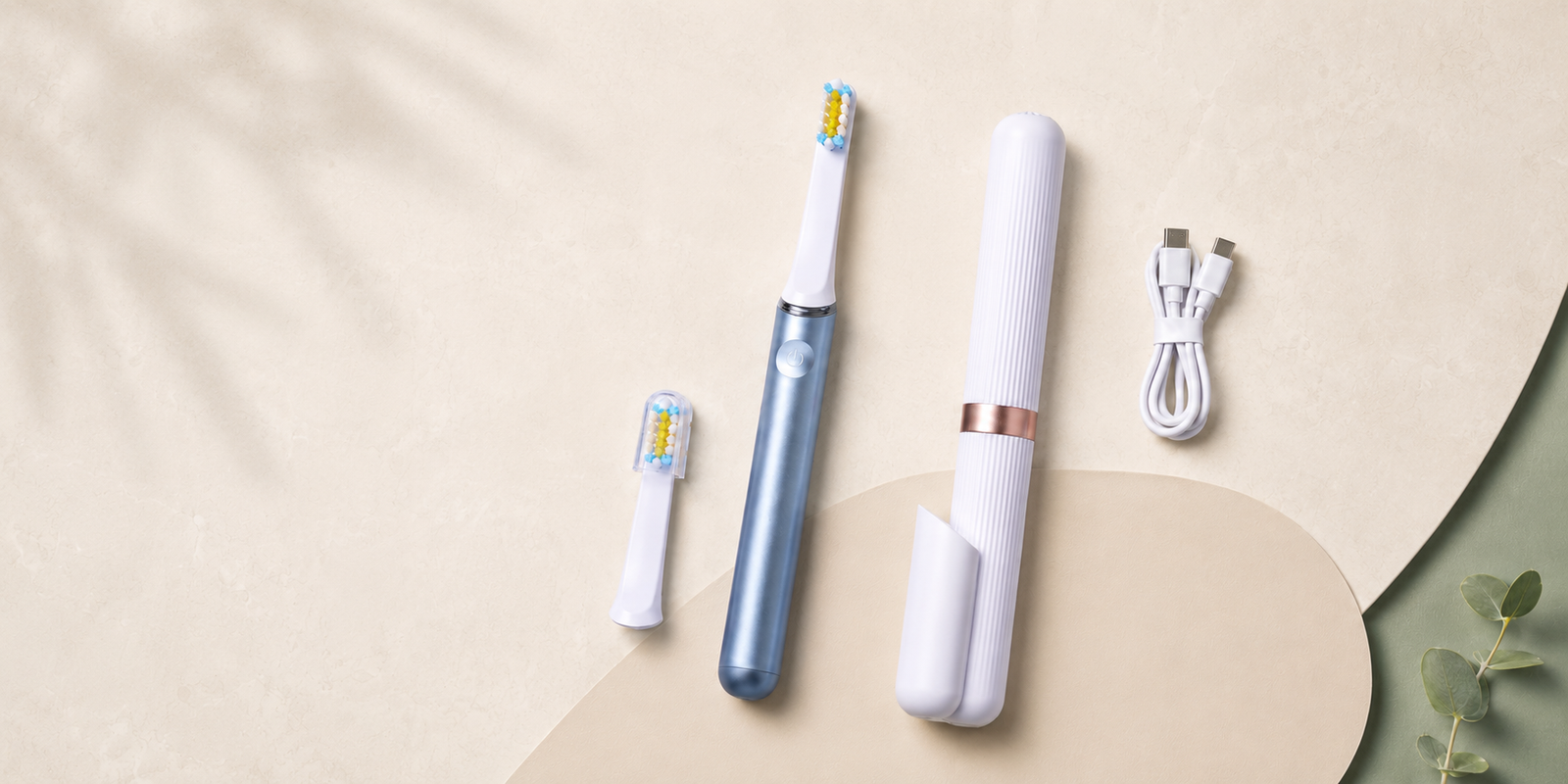 Flat lay of AeroBrush Pro, two brush heads, USB-C cable, travel case, and quick-start card