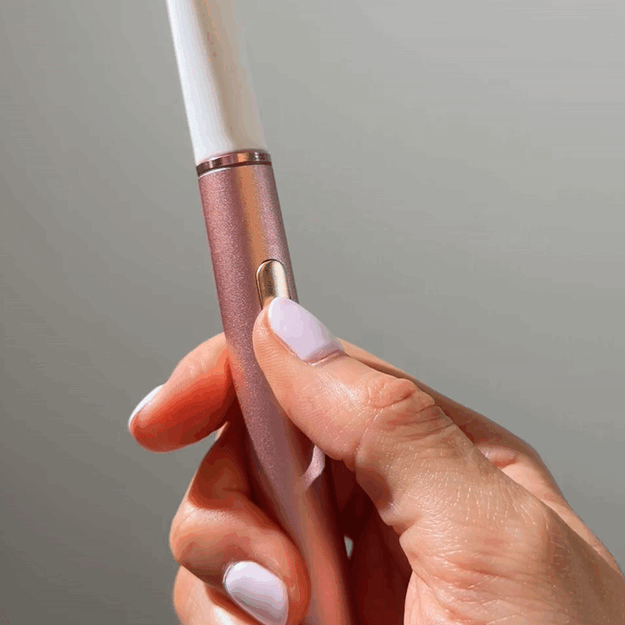 Gliding the AeroFloss Pro tip between teeth