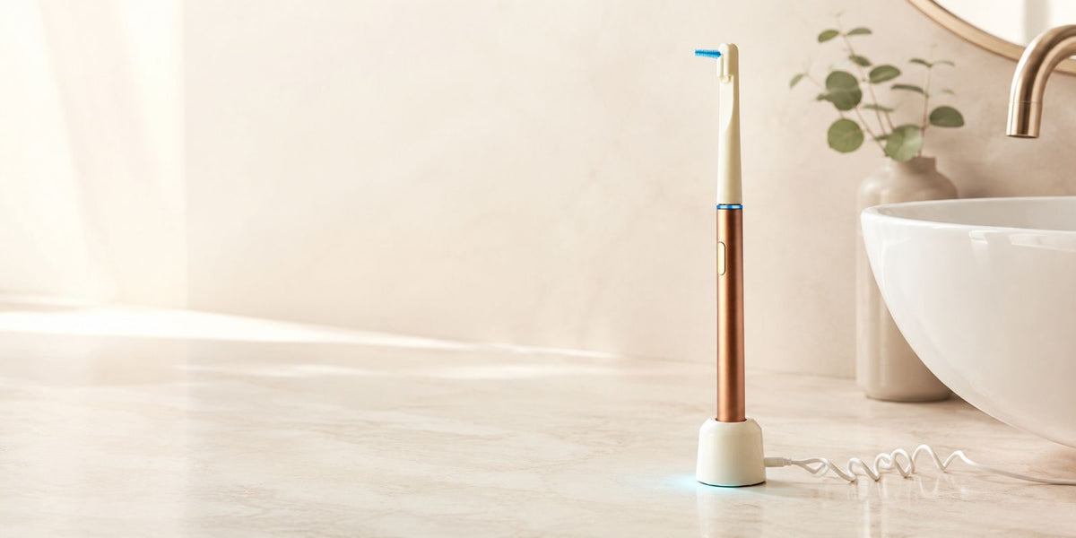 AeroFloss Pro standing on its wireless charging base
