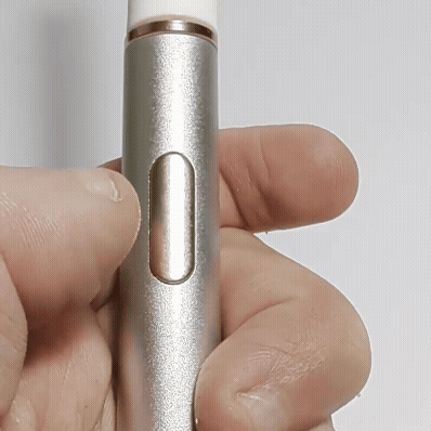 Gliding the AeroFloss Pro tip between teeth